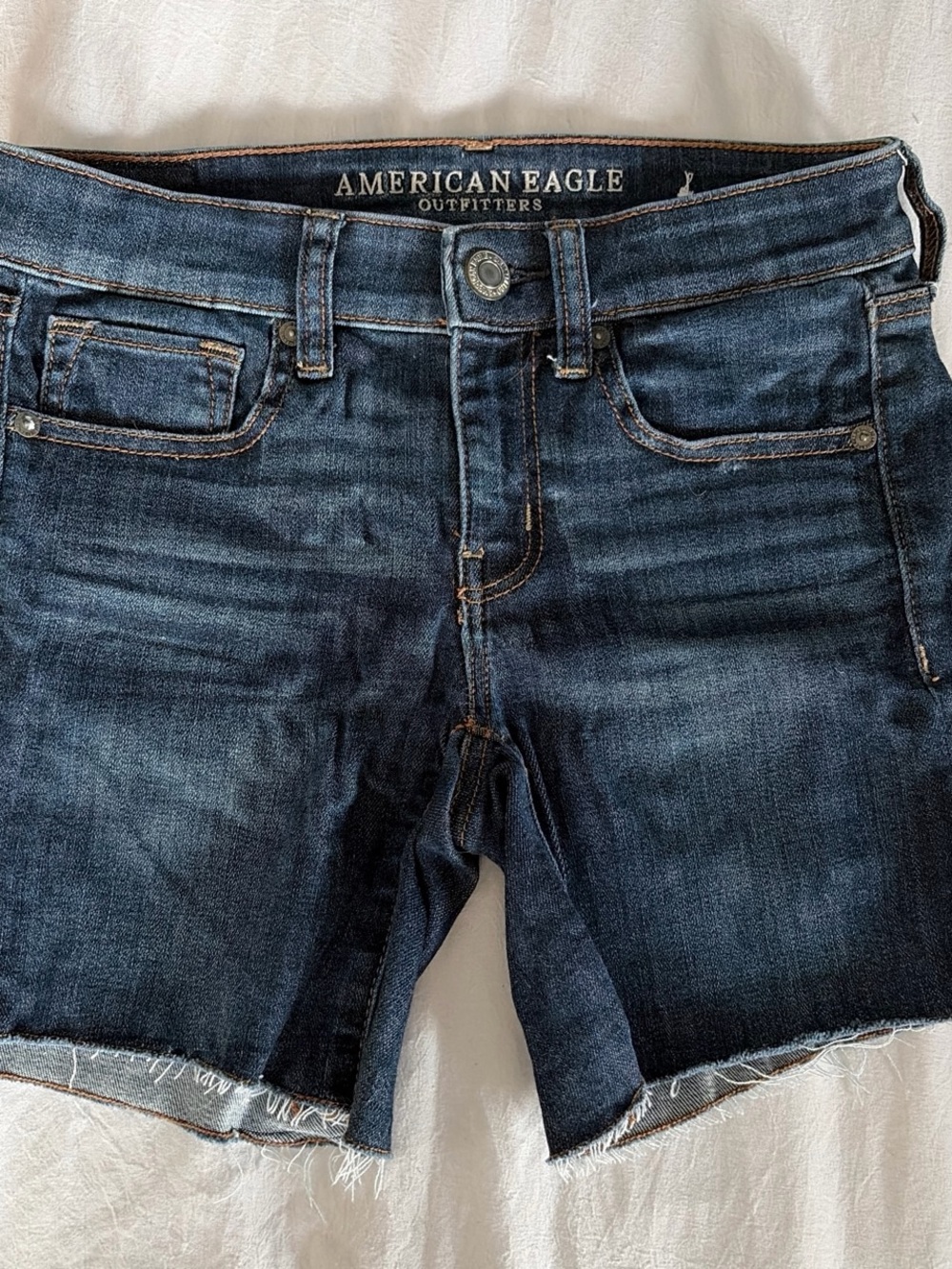 American Eagle Outfitters dark blue denim shorts with orange stitching